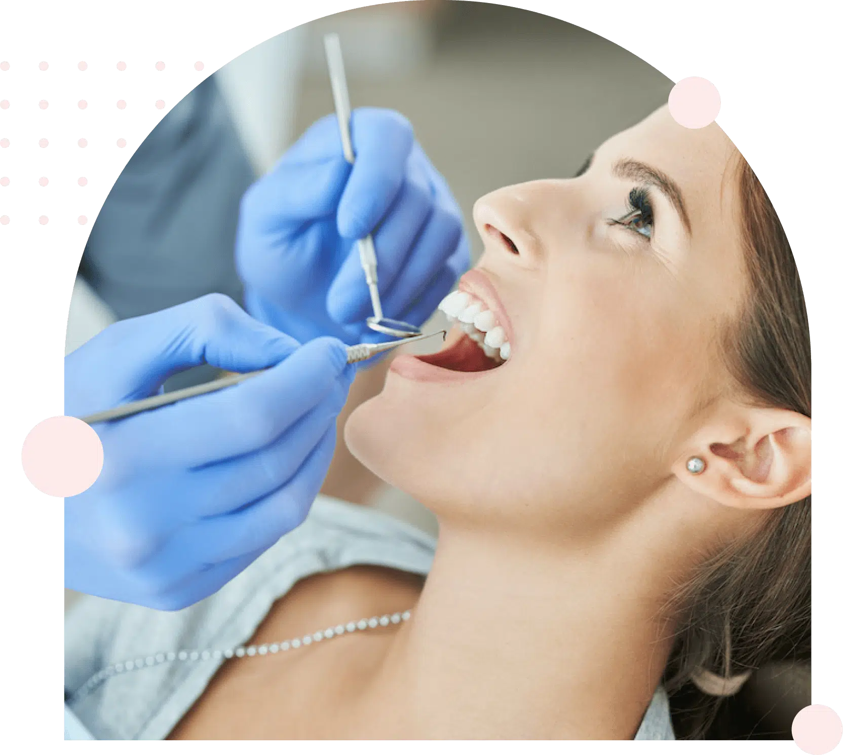 Woman receiving dental exam from gloved dentist