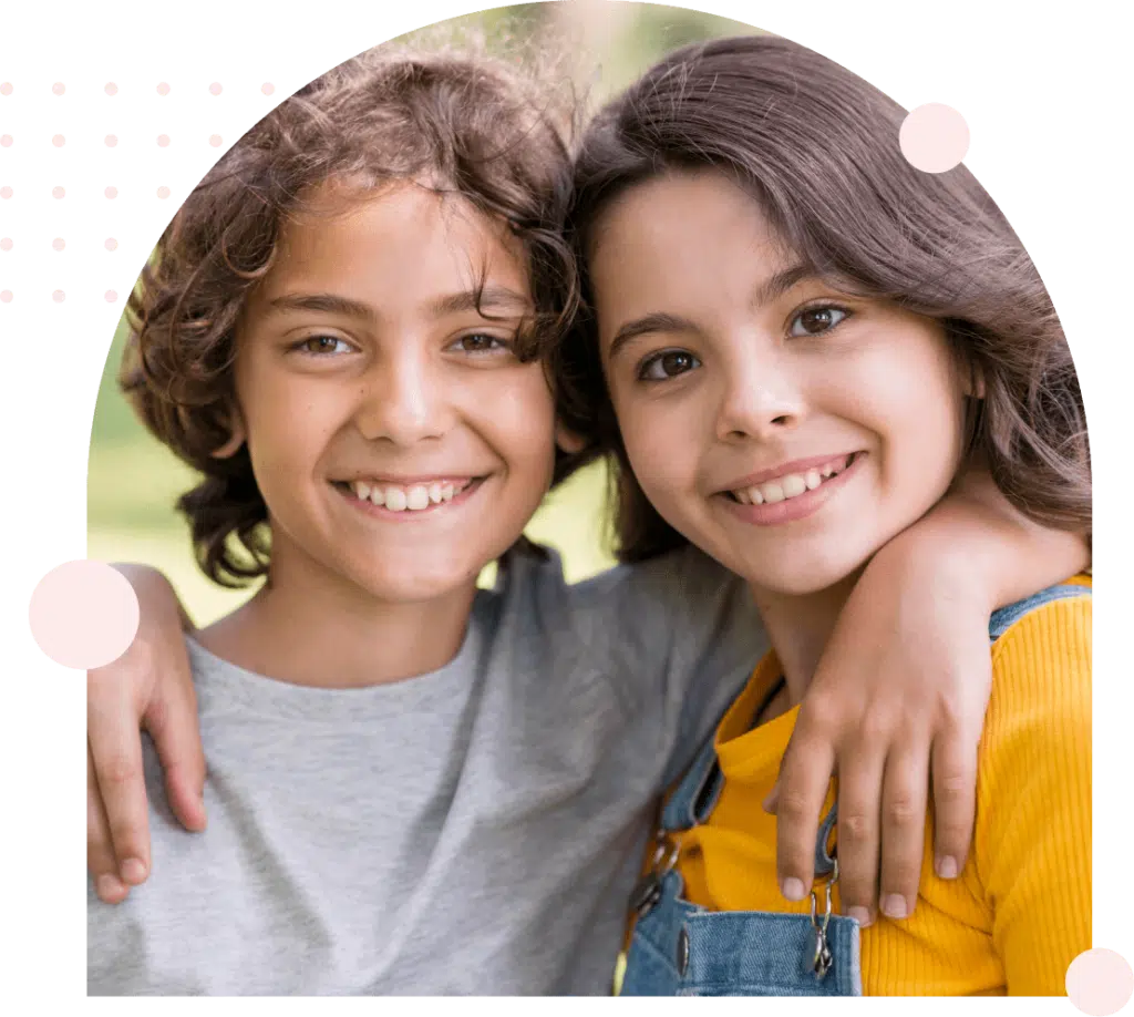 Two smiling children with arms around each other